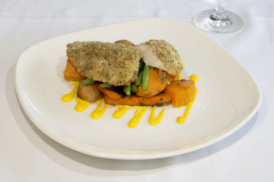 Wild Gulf Barramundi fillet topped with herb crumb, baked and served on vegetables and potatoes with saffron aioli.