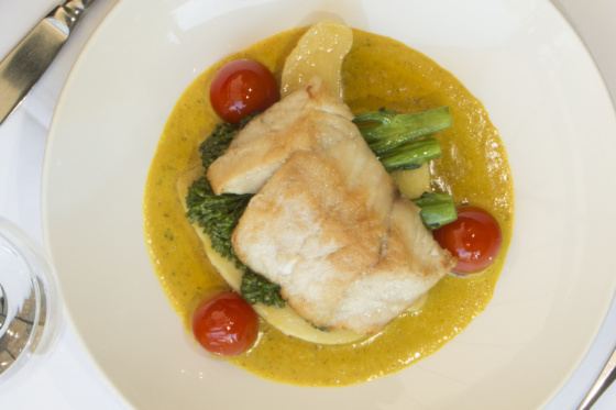 Wild Gulf Barramundi fillet oven baked, served on coconut curried sauce, potatoes, greens and tomatoes